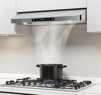 A right view of the IKTCH-IKC01 under cabinet range hood for out Top 5 Best Under Cabinet Range Hoods of 2023 listicle. The range hood is incorporated into a kitchen and is sucking up steam from a pan.