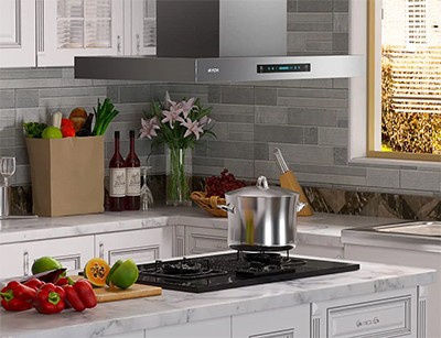 A kitchen view of the IKTCH IKIS02-36 (30/36/42") island range hood for our Top 3 Best Island Range Hoods of 2023 listicle. The range hood is installed in a kitchen.