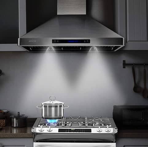 A kitchen view of the IKTCH IKP02R-36 (36") Chimney Range Hood for our Top 5 Wall Mount Chimney Range Hoods of 2022 listicle. The range hood is installed in a kitchen.