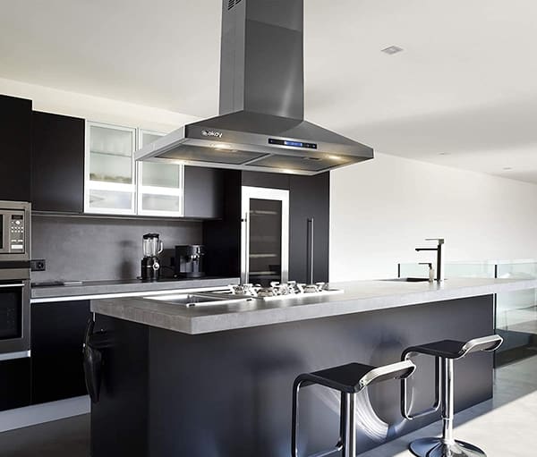 A kitchen view of the 3. AKDY RH0405 (30") Chimney Range Hood for our The Top 3 Best Island Range Hoods of 2022 listicle. The range hood is installed in a kitchen.