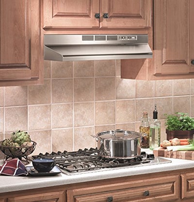 A kitchen view of the Broan-NuTone 413004 and 403004 (30") Under Cabinet range hood for our The Top 5 Best Under Cabinet Range Hoods of 2022 listicle. The range hood is installed in a kitchen.
