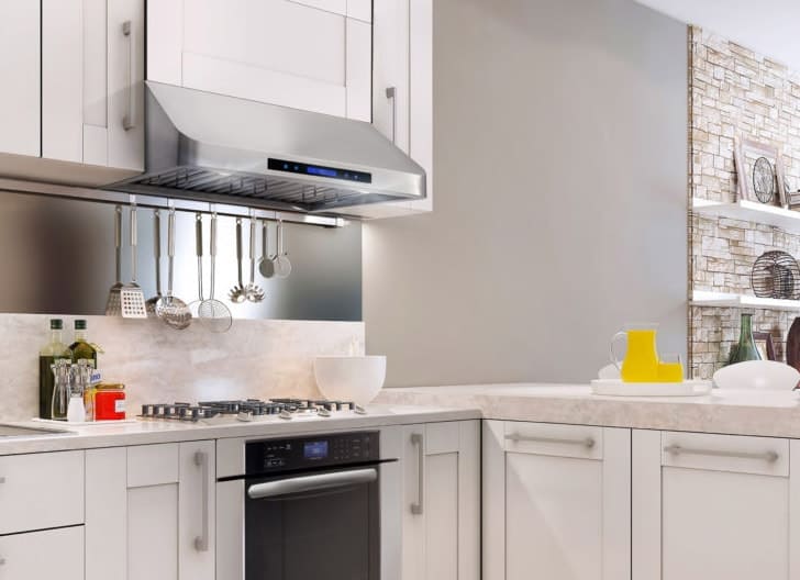 A kitchen view of the Cosmo COS-QS75 (30") Under Cabinet range hood for our The Top 5 Best Under Cabinet Range Hoods of 2022 listicle. The range hood is installed in a kitchen.