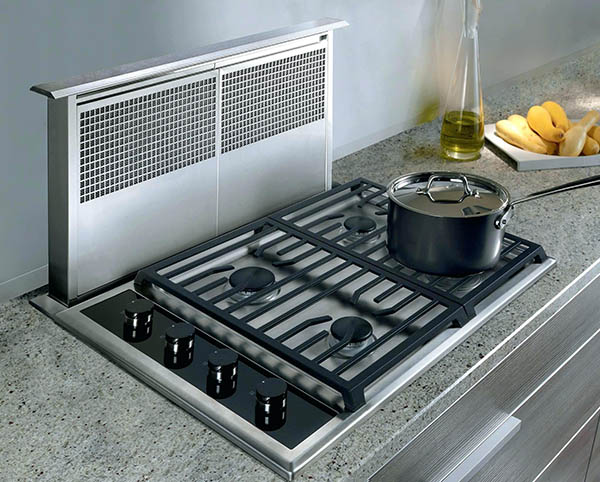 A downdraft ventilation installed behind the stove. There's a pan on the stove.