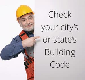 A picture of a man with a hard hat. het's pointing to a text that says "Check your city's or state's building code"