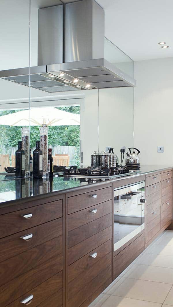 A kitchen with a wall mounted range hood installed, but it's installed way too high