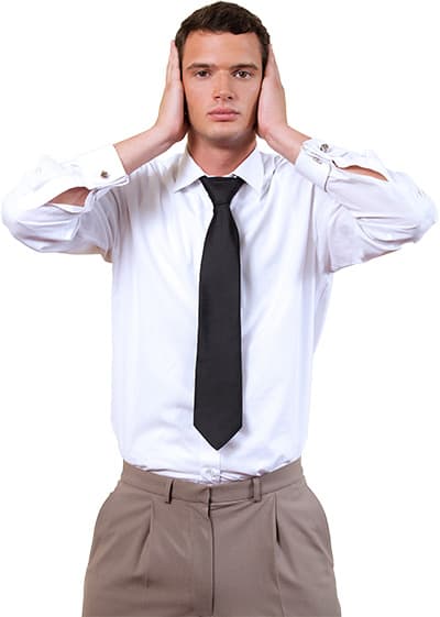 Man with with a dark tie and white dress shirt with his hands covering his ears.