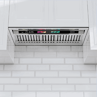 A kitchen shot of the BRANO BU09B-V30 (30) range hood insert. It has two baffle filters and a touch screen. It looks futuristic. It's incorportated in a white cabinet.