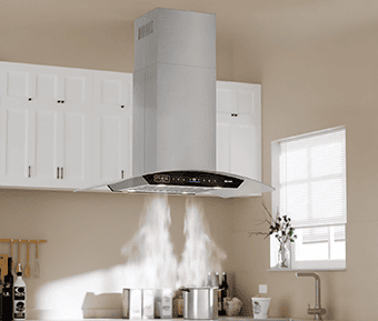 Kitchen shot of the BRANO SL22SV36 island range hood. The range hood is brushed stainless steel with a black touch screen and a tempered glass canopy. The range hood is installed in a kitchen, with sunlight coming in from a window. There are two pots underneath the range hood with steam coming off of them.